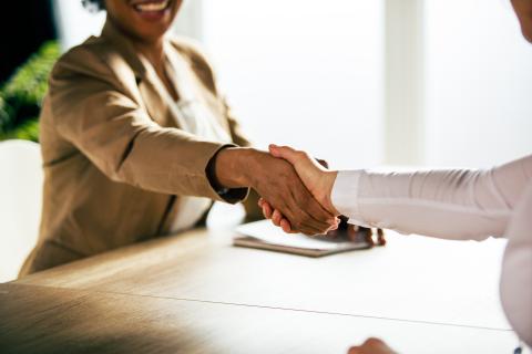 Waco Title associate shaking hands with customer after successful title transfer